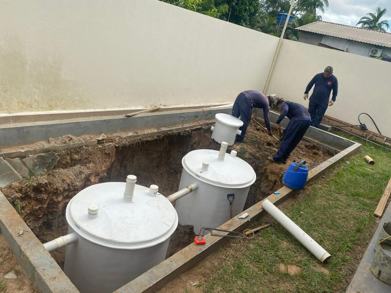 dois homens instalando estação de tratamento de água